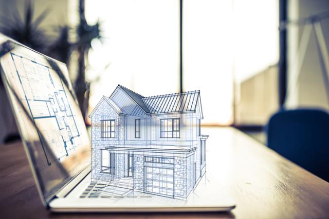Grafik von Haus in 3D auf Laptop stehend
