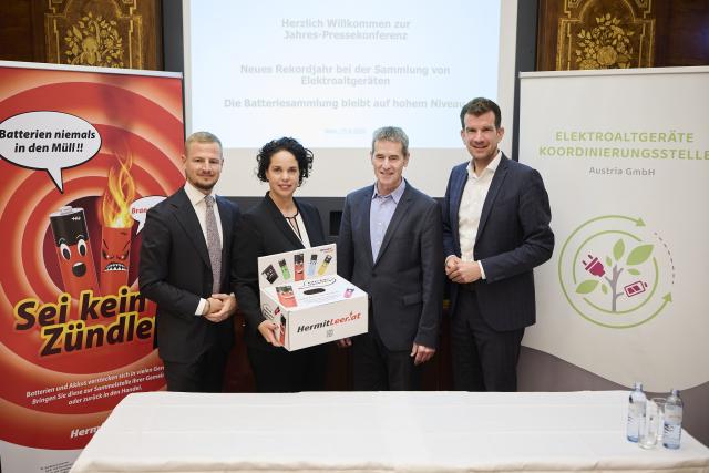 Vier Vertreter:innen der Elektroaltgeräte Koordinierungsstelle, des Bundesministeriums und der kommunalen Abfallwirtschaft bei der EAK-Jahrespressekonferenz 2026. Im Vordergrund steht eine „Her mit Leer“-Sammelbox, im Hintergrund sind Informationsplakate zur Batteriesammlung und das EAK-Logo zu sehen.