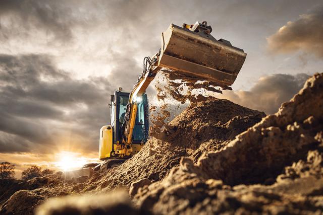 Bagger auf Deponie hebt Schaufel